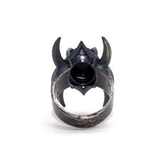 Inspired by Lord of The Rings and crown of the Nazgul. This ring pulses with dark power and raw strength. Each ring is set with a high quality black onyx. I hand texture each ring with a raw, multidirectional pattern to accentuate the stone’s physicality. Hand cast in sterling silver, oxidized and finished to 400 grit Need your size in a quarter size? Feel free to reach out before or during purchasing. *Please note: all pieces take 2-3 weeks to complete Black Metal Skull Ring Symbolic Style, Symbolic Black Metal Skull Ring, Brutalist Style Open Ring Jewelry, Gothic Adjustable Gemstone Rings, Brutalist Open Ring With Oxidized Finish, Brutalist Oxidized Open Ring Jewelry, Adjustable Gothic Rings With Gemstone, Adjustable Gothic Gemstone Rings, Symbolic Black Rings With Oxidized Finish