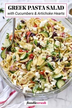 greek pasta salad with cucumbers and artichoke hearts in a glass bowl