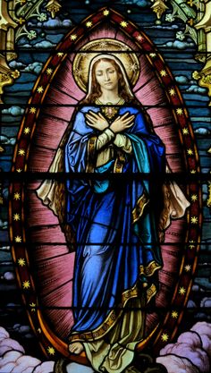 a stained glass window depicting the virgin mary