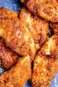 some fried chicken pieces on a blue plate