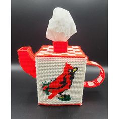 a red and white tissue dispenser with a st louis cardinals design on it