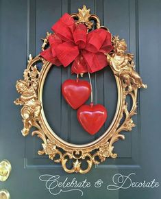 two red hearts hanging from a gold frame on a door with the words celebrate and decorate