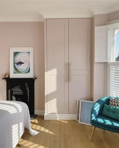 a bedroom with pink walls and white furniture