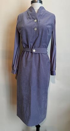 1970's long sleeve shift dress with matching belt.  Manufactured by "Ms. Z" the main body of the dress is in a plush lilac polyester while the sleeves are in plain polyester.  The front placket has a two white and gold  buttons in a geometrical design, there is a matching button on the fabric belt and smaller matching buttons on the sleeves.  The sleeves have a pleating detail.  It closes with a 22" center back zipper.  There are not any noticeable stains or discoloration.  This item is in great vintage condition. Measurements: Armpit to Armpit:  36"  (measured flat then doubled) Waist:  34"  (measured flat then doubled) Hip:  38"  (measured flat then doubled) Nape of Neck to Hemline:  42" Shoulder to Shoulder:  15" Sleeve Length:  22" Geometrical Design, Nape Of Neck, Long Sleeve Shift Dress, Fabric Belt, Gold Buttons, Dress Clothes For Women, Vintage 1970s, Shoulder To Shoulder, Shift Dress