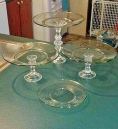 three clear glass dishes sitting on top of a green countertop next to an oven