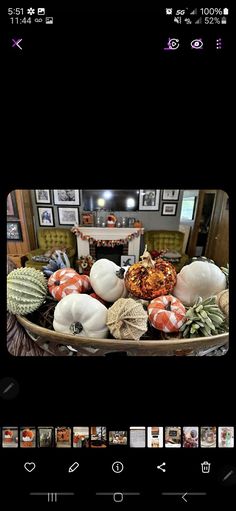 a bowl full of pumpkins sitting on top of a table