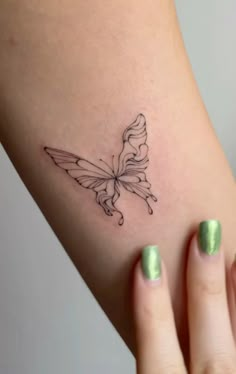 a woman's arm with a butterfly tattoo on the left side of her body