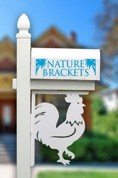 there is a sign that says nature brackets in front of a house with trees and bushes