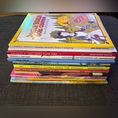 a stack of children's books sitting on top of a table