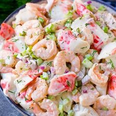 a bowl filled with shrimp salad on top of a table