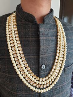 Gold Kundan Pearl Necklace For Groom, Sabyasachi Sherwani Necklace, Pearl Necklace, Long Necklace, Indian Wedding Jewelry, Pakistani Wedding 4 Layered Gold Kundan and Pearl Beads Necklace An elegant gold and pearl bead necklace with the most stunning festoon. The perfect accessory for your occasion. This necklace is handcrafted with love Necklace Length: Choose from the drop-down menu (comes with adjustable back Dori/cord) (The length of the necklace in the image is 26 inches) Package: 1 Necklace Material: Premium Pearl beads, gold kundan beads Care: Store in an airtight plastic bag or box. Keep away from water, moist places & fragrance For Express shipping, the option is available in the drop-down menu at checkout. If you need any help regarding placing an order or express shipping, feel Gold Kundan Sherwani For Festivals, White Kundan Elegant Sherwani, Elegant White Kundan Sherwani, Elegant White Sherwani With Kundan, Kundan Temple Necklace With Gota Work For Weddings, White Temple Jewelry Mala For Weddings, Festive Gota Work Temple Necklace For Weddings, Traditional Wedding Mala With Tilla, Traditional Tilla Mala For Wedding