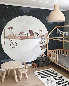 a child's bedroom with a large mural on the wall