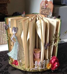 an open book decorated with paper and flowers