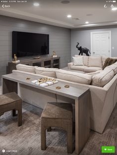 a living room filled with furniture and a flat screen tv mounted to the side of a wall