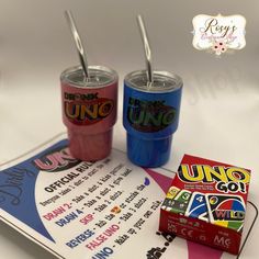 two drink cups with straws on top of a menu and candy bar wrapper