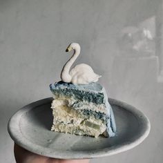 a piece of cake with a white swan on top