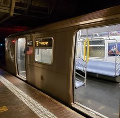 a subway train with its doors open at night