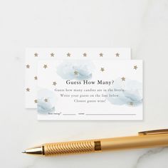 a pen sitting on top of a white table next to a card with the words guess how many?