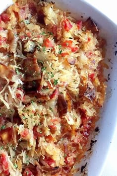 a white bowl filled with food on top of a table