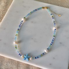 handmade with love+light to bring you spiritual wealth & happiness ✨ ready for summertime? don't forget to pack this in your beach bag! the tropical colors of the seed beads mixed in with freshwater pearls brings all the ocean vibes!  * this necklace is made of real natural freshwater pearls, seed beads and gold plated 304 stainless steel findings that are tarnish resistant.  * length: approximately 16" with 2" extender chain *comes with gift bag 𝐣𝐞𝐰𝐞𝐥𝐫𝐲 𝐜𝐚𝐫𝐞 𝐢𝐧𝐬𝐭𝐫𝐮𝐜𝐭𝐢𝐨𝐧𝐬: please put your jewelry on last after cosmetics, perfume, hairspray & other chemical substances that can be corrosive. avoid getting wet! remove when entering water, before sleeping or before working out. keep away from chlorine & keep jewelry in the bag it came with when not wearing. 𝐬𝐡𝐢𝐩𝐩𝐢? Cheap Beach Jewelry With Heart Beads, Cheap Beach Jewelry With Gemstone Beads, Cheap Dangling Beads Necklace For Beach, Cheap Beaded Beachy Necklaces For Beach Season, Cheap Beaded Chain Necklaces For Beach, Cheap Blue Necklaces For The Beach, Cheap Silver Beaded Jewelry For The Beach, Cheap Handmade Summer Jewelry, Cheap Beach Necklaces With Spacer Beads