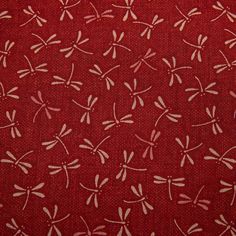 red fabric with white dragonflies on it