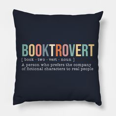 a black pillow with the words booktrovert printed in multicolored letters