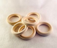 five wooden rings sitting on top of a white sheet