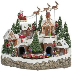 a christmas village with santa's sleigh and reindeers on the roof