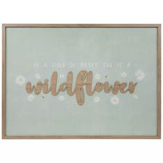 a wooden sign that says wildflower with daisies in the bottom right hand corner