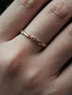 a woman's hand with a gold ring on it