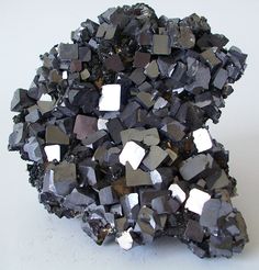 a pile of black rocks sitting on top of a white table