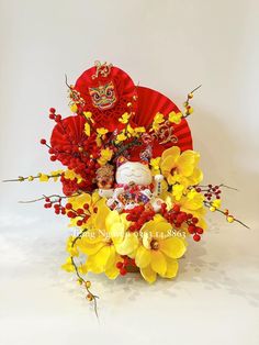 an arrangement of flowers in a tea pot