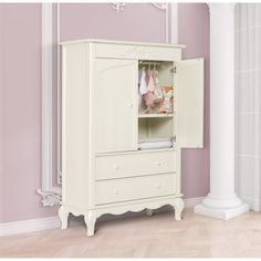 a white armoire in a room with pink walls