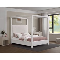 a white bed sitting in a bedroom next to a window