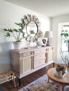 a living room filled with furniture and a large mirror