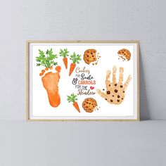 a print with hand prints and carrots on the wall next to a white shelf