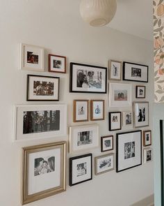 a wall full of pictures and framed photographs