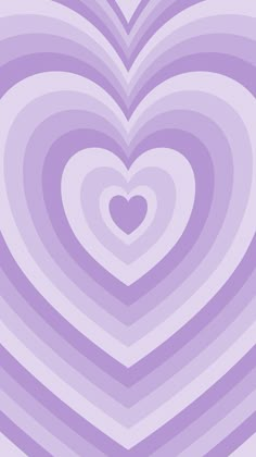 a heart shaped object in the middle of a purple and white striped wallpaper pattern