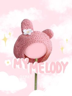 a crocheted teddy bear hat on top of a pink flower with the words my melody written below it