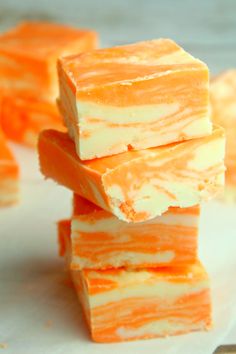 several pieces of orange and white candy stacked on top of each other