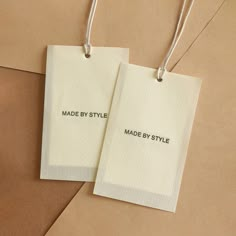 two tags with the words made by style and made by style are hanging on brown envelopes