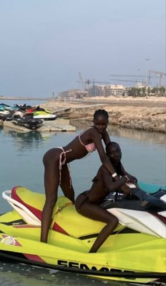 two people on a yellow and red jet ski