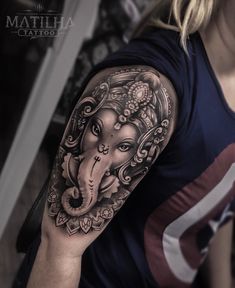 an elephant tattoo on the arm and shoulder