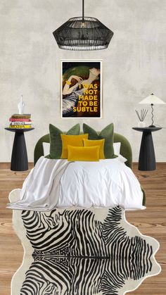 a bed with zebra print on the cover and pillows in front of a poster hanging above it