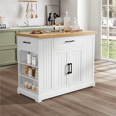 a white kitchen island with wooden counter top