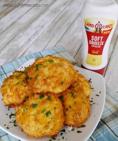 some fried food on a plate next to a bottle of mayonnaise