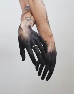 a person with black and white paint on their hands