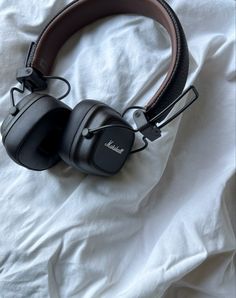 a pair of headphones sitting on top of a bed