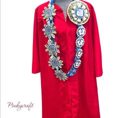 a woman's red graduation gown with blue and silver accents