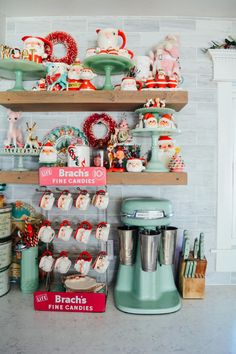 the shelves are filled with christmas decorations and other items on display in this kitchen area